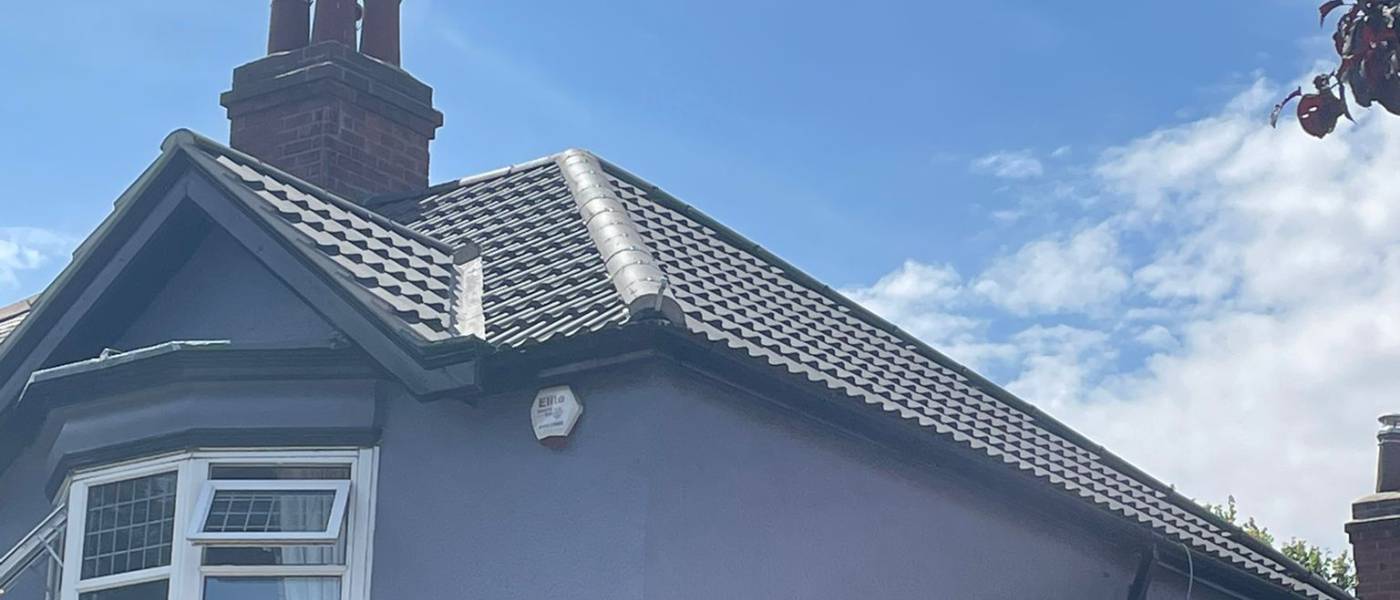 New pitched roof tiles and ridge on a bay fronted house