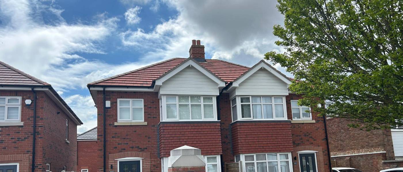 Semi detached houses in Grimsby with a newly completed red tiled roof by ABM Roofing