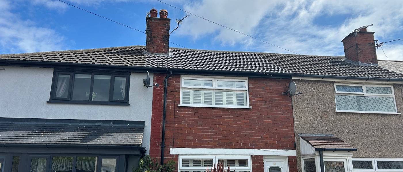 Re-roofed terraced houses with new tiles and repointed chimney